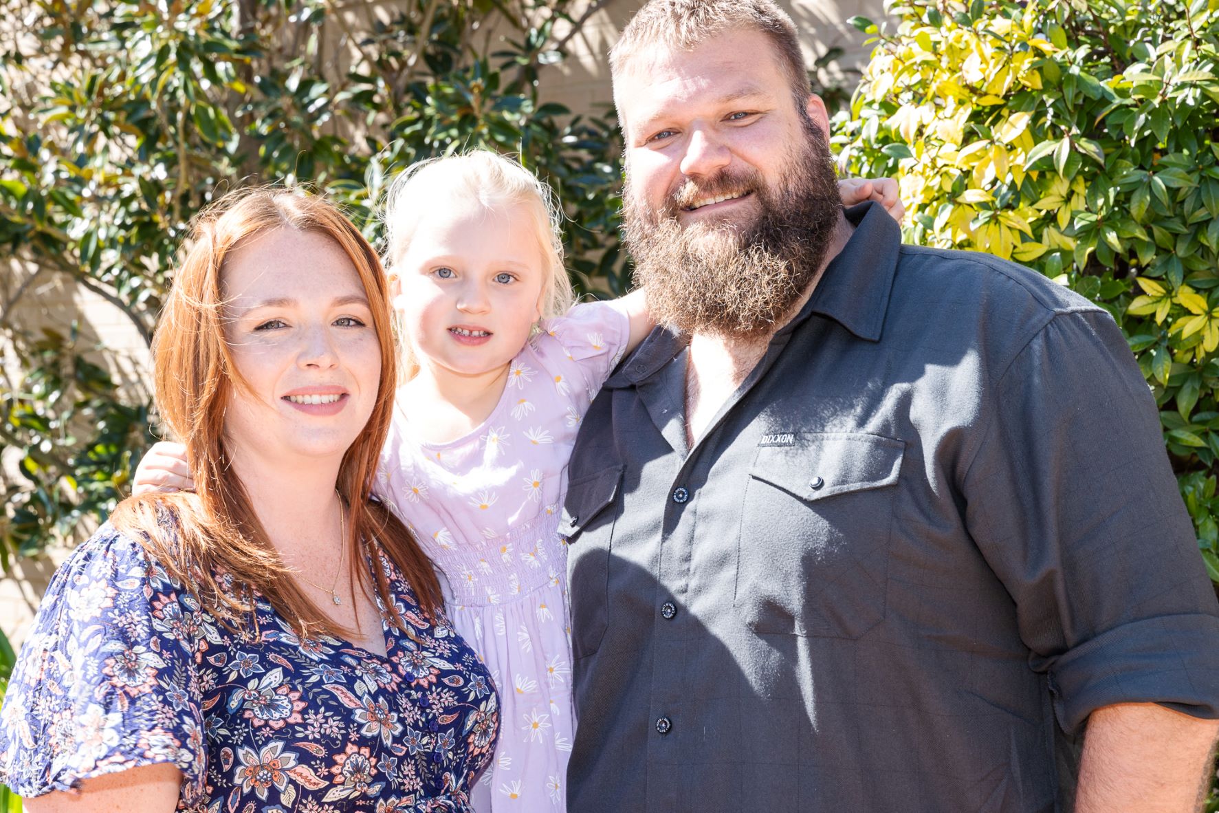 Family smiling. Mum Dad daughter